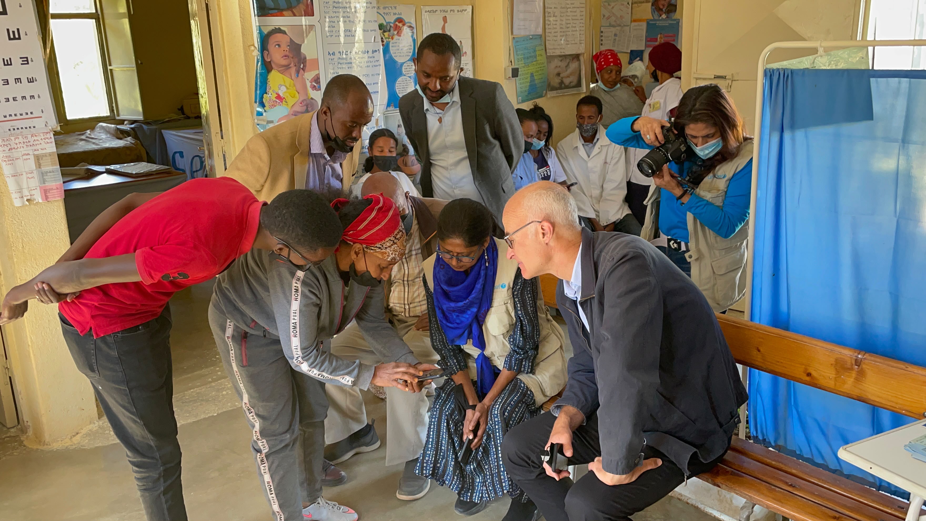 African Vision team documenting a community health program alongside UNICEF field staff